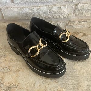 Black heeled loafers with gold detail